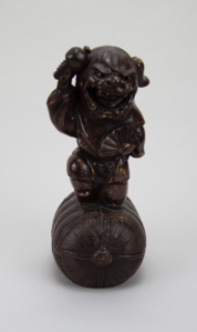 Image of Lion-headed figure standing on a sake cask