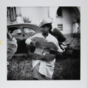 Image of Young gypsy girl with broken guitar, Stes Maries de la Mer